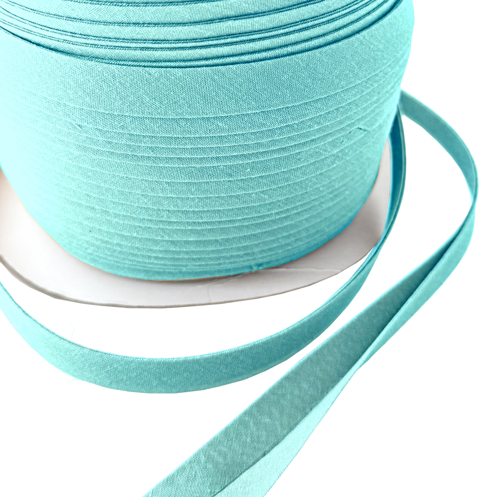 close up of the aqua 1/2" double fold bias tape on a spool from Heit's Wholesale bulk sewing supply 