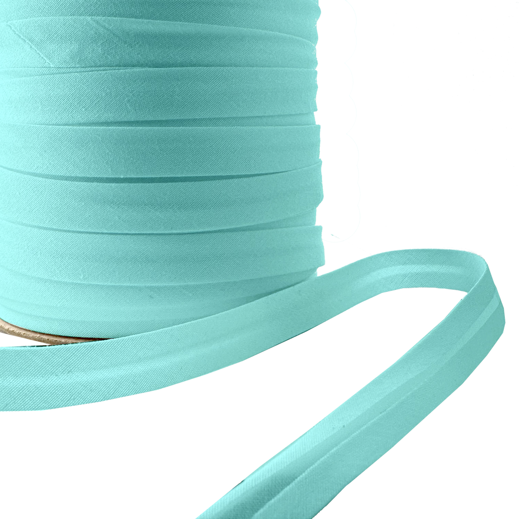 close up of the aqua 1/2" single fold bias tape on a spool from Heit's Wholesale bulk sewing supply company