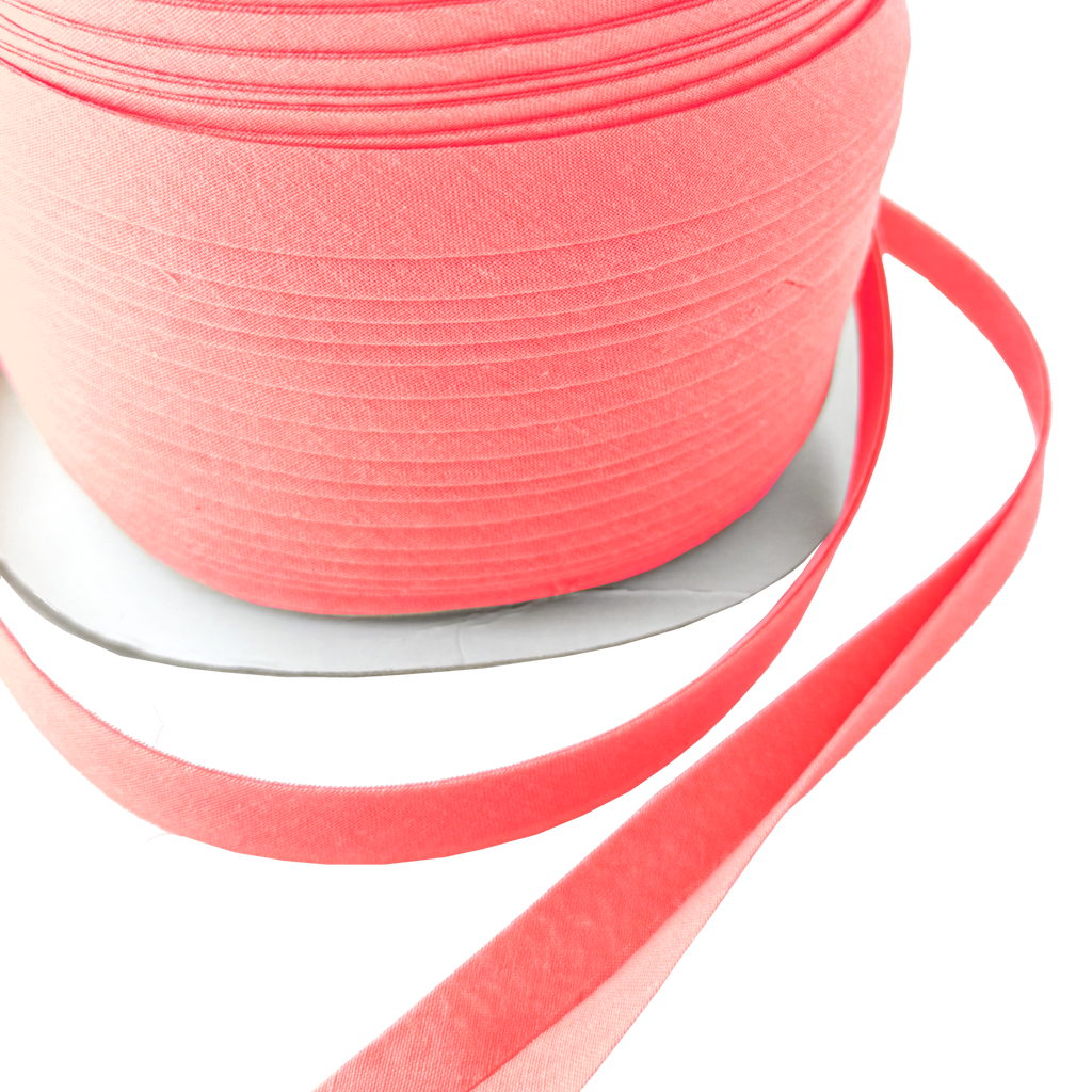 close up of the brandy pink 1/2" double fold bias tape on a spool from Heit's Wholesale bulk sewing supply company