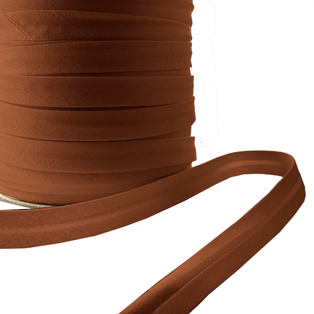 close up of the brown 1/2" single fold bias tape on a spool from Heit's Wholesale bulk sewing supply company