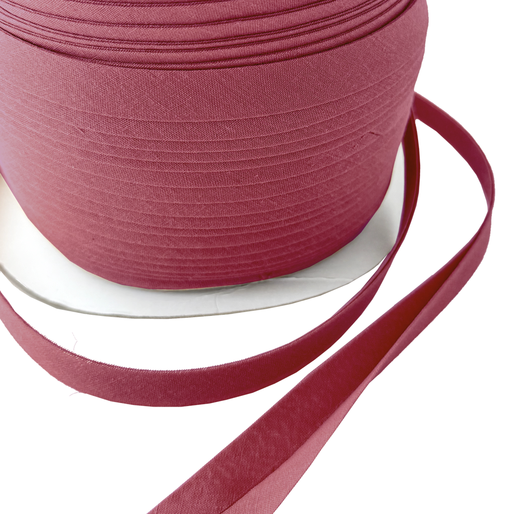 close up of the copper 1/2" double fold bias tape on a spool from Heit's Wholesale bulk sewing supply company