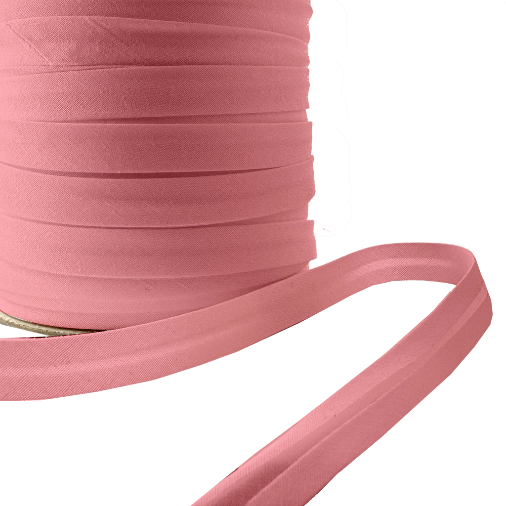 close up of the copper 1/2" single fold bias tape on a spool from Heit's Wholesale bulk sewing supply company