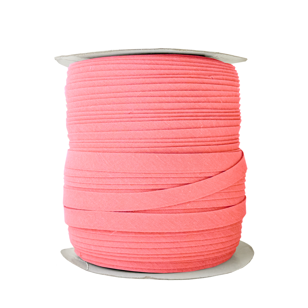 coral pink 1/2" double fold bias tape on a spool from Heit's Wholesale bulk sewing supply company