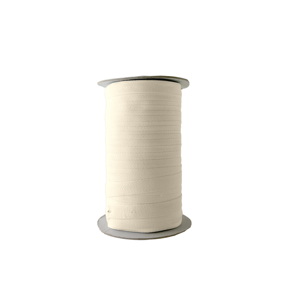 ivory 1/2" cotton twill tape on a spool from Heit's Wholesale bulk sewing supply company