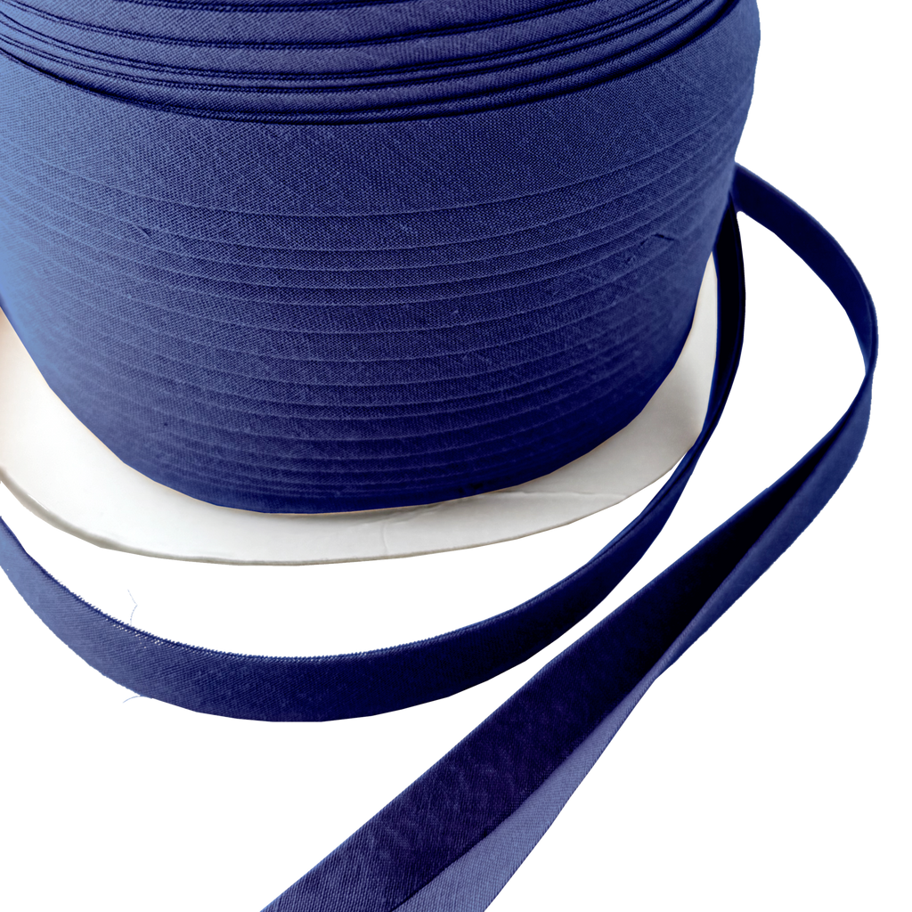 close up of the deep royal blue 1/2" double fold bias tape on a spool from Heit's Wholesale bulk sewing supply company