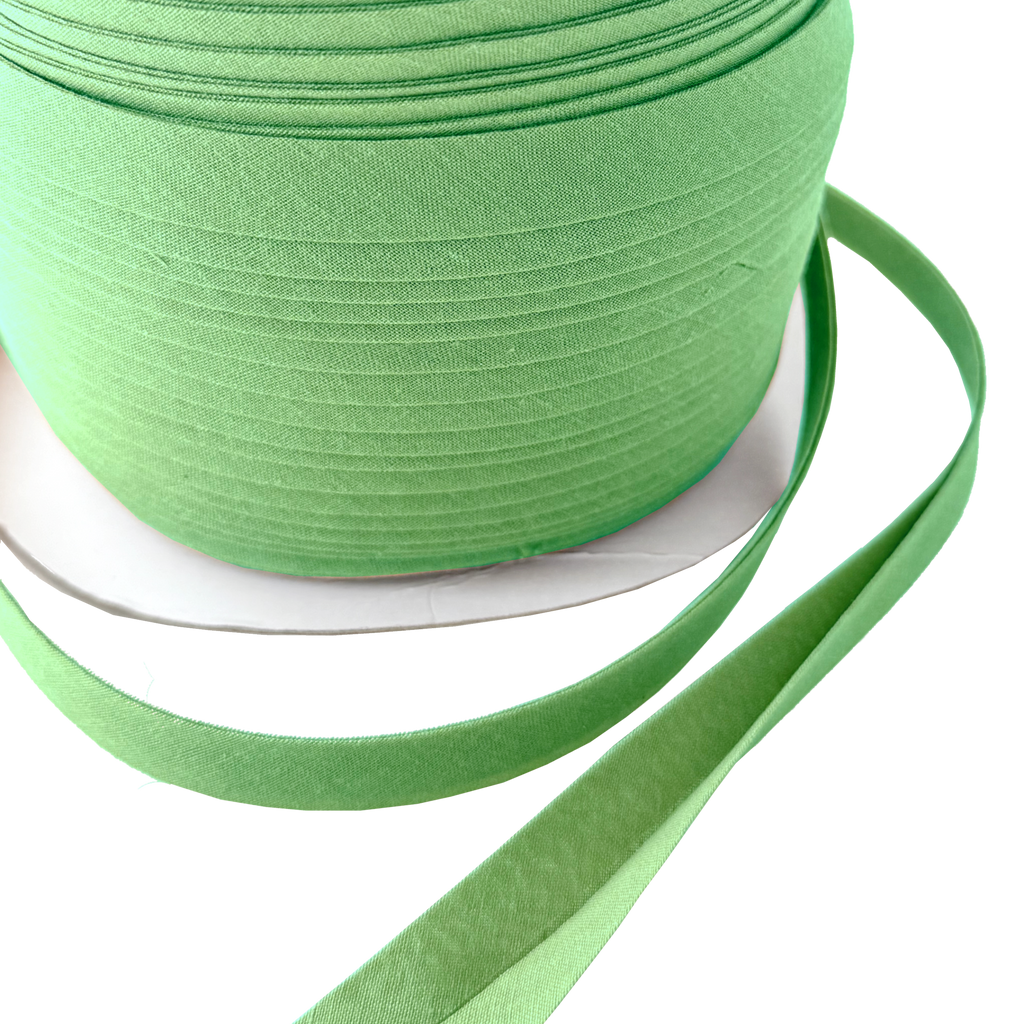 close up of the gypsy green 1/2" double fold bias tape on a spool from Heit's Wholesale bulk sewing supply company
