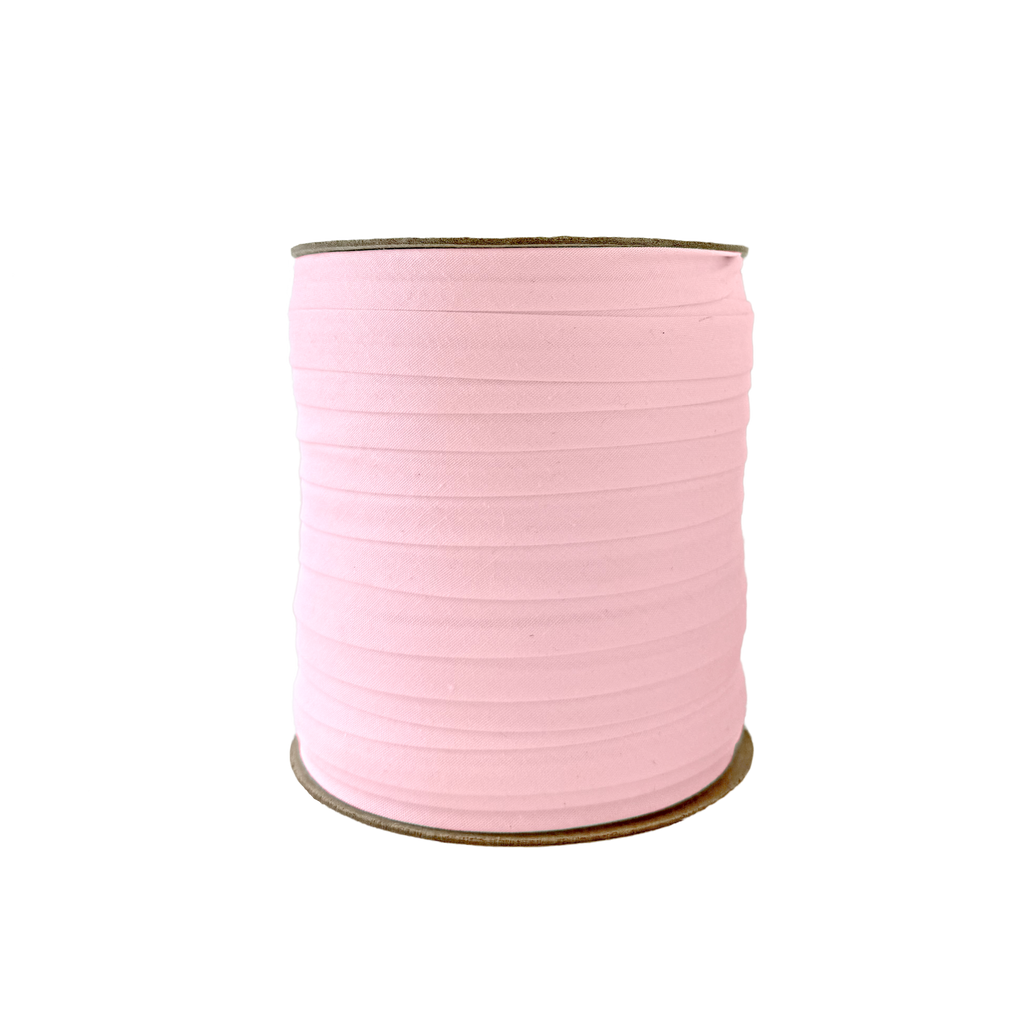 petal pink 1/2" single fold bias tape on a spool from Heit's Wholesale bulk sewing supply company