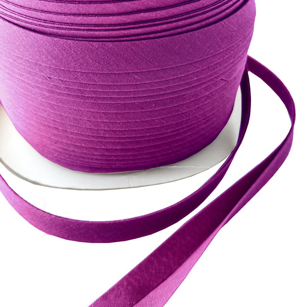 close up of the plum 1/2" double fold bias tape on a spool from Heit's Wholesale bulk sewing supply company