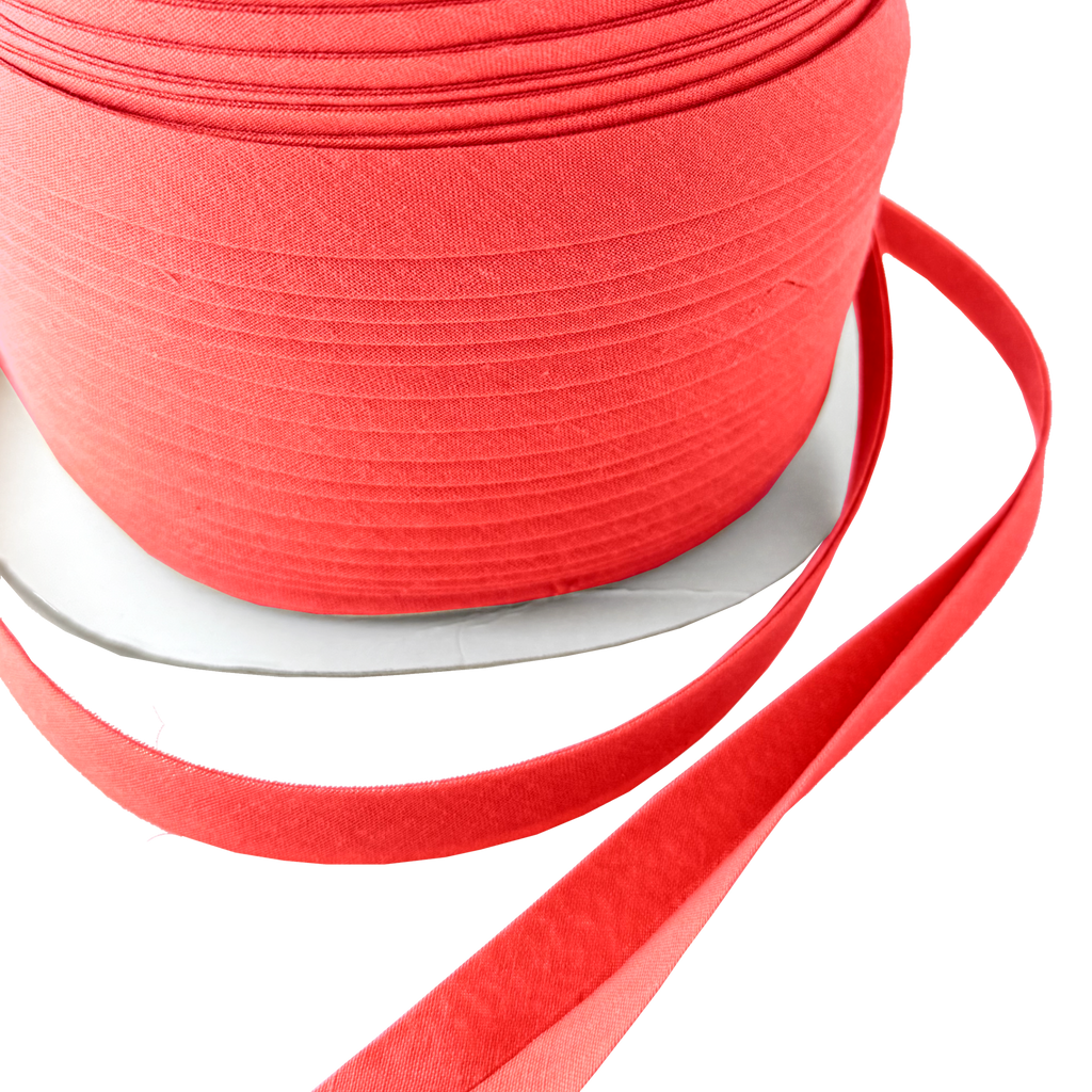 close up of the red 1/2" double fold bias tape on a spool from Heit's Wholesale bulk sewing supply company