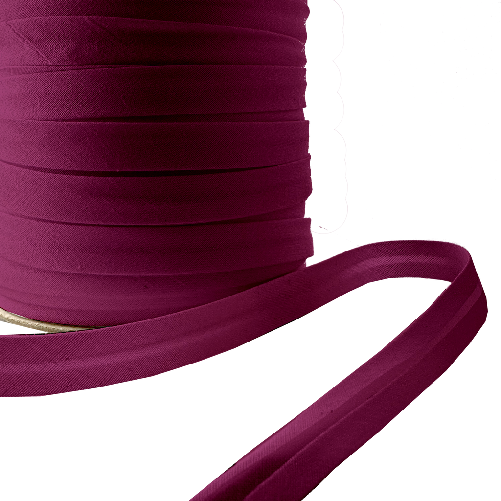 close up of the ruby 1/2" single fold bias tape on a spool from Heit's Wholesale bulk sewing supply company