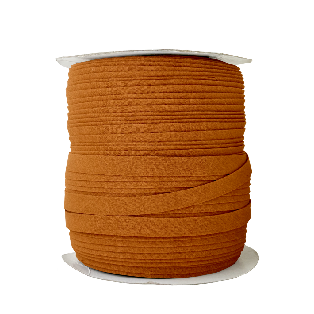 sandlewood 1/2" double fold bias tape on a spool from Heit's Wholesale bulk sewing supply company