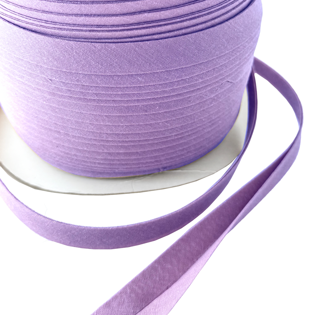close up of the violet 1/2" double fold bias tape on a spool from Heit's Wholesale bulk sewing supply company