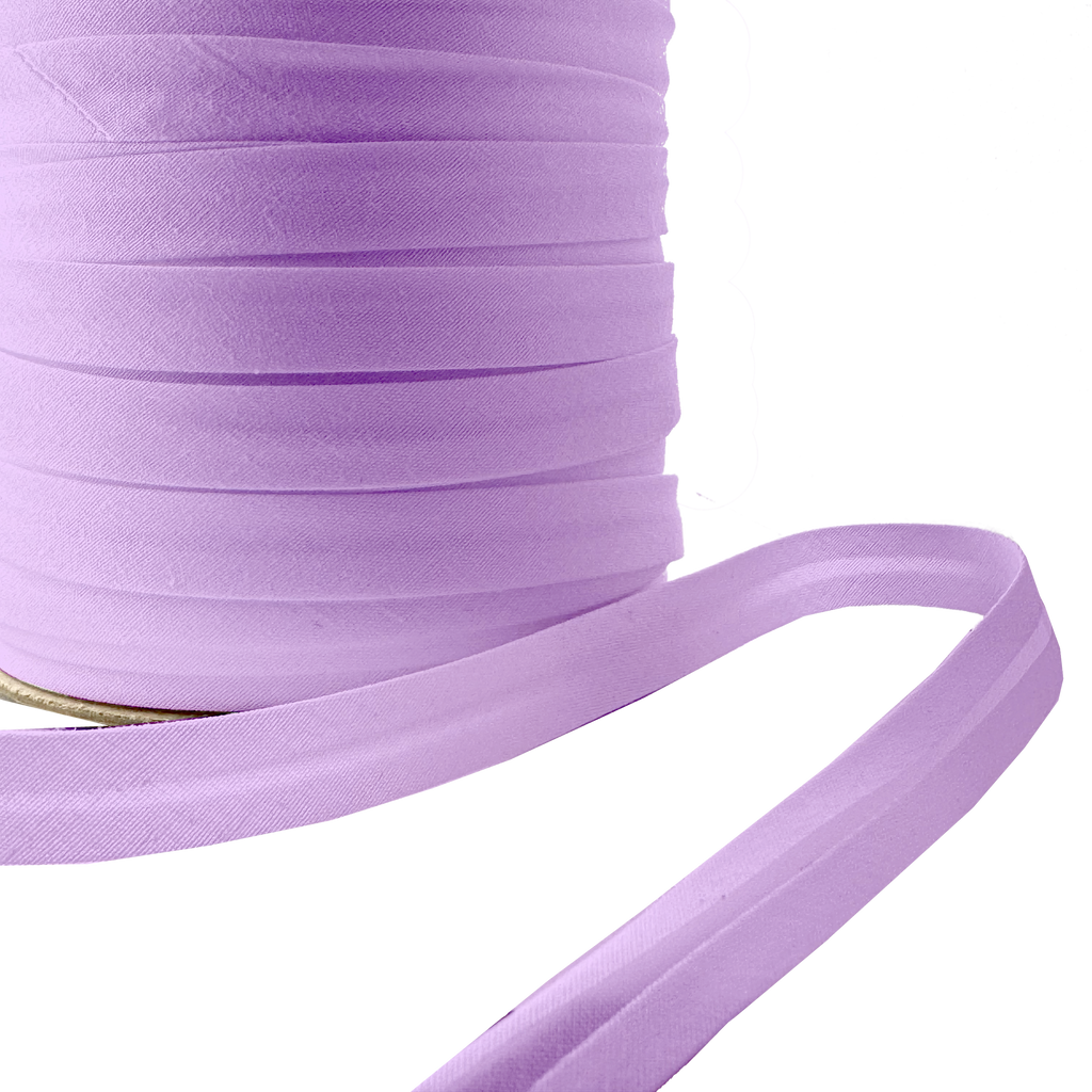 close up of the violet 1/2" single fold bias tape on a spool from Heit's Wholesale bulk sewing supply company