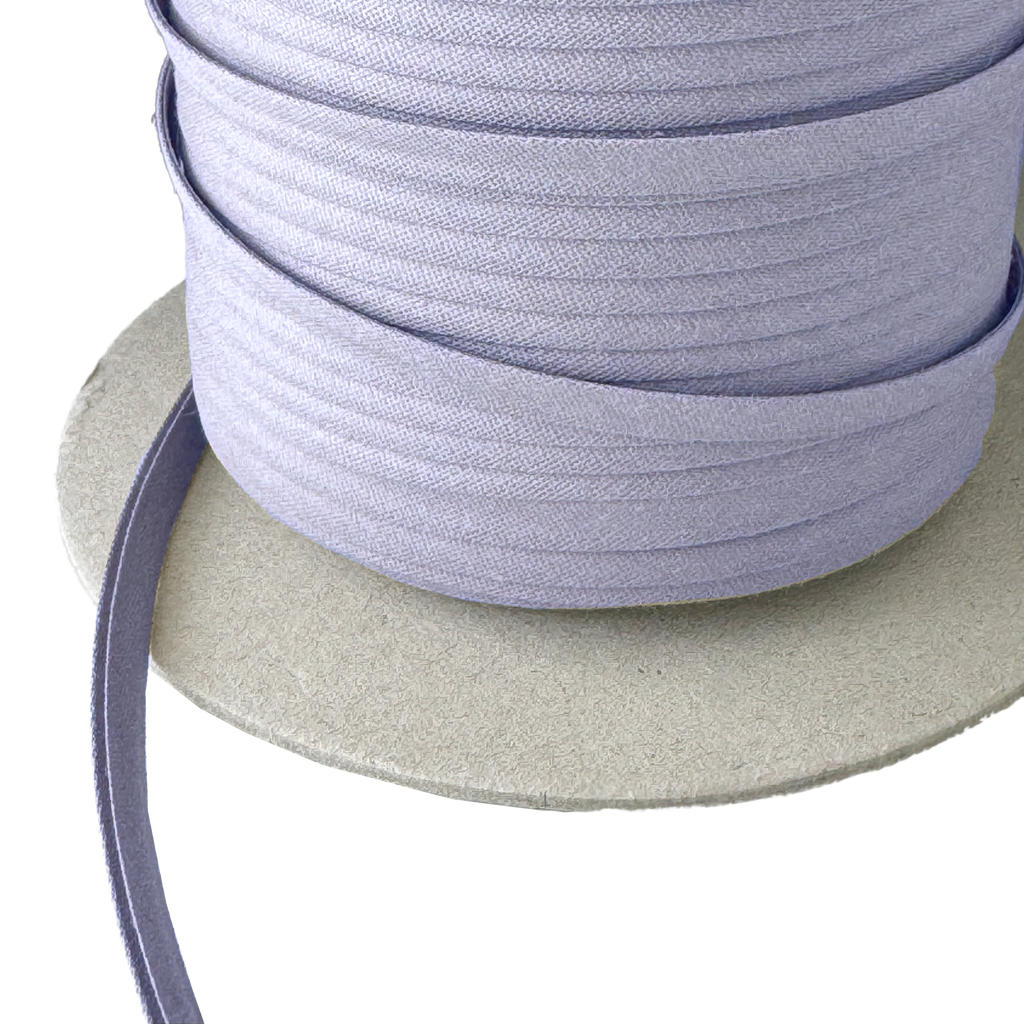close up of the boca blue 1/4" double fold bias tape on a spool from Heit's Wholesale bulk sewing supply company