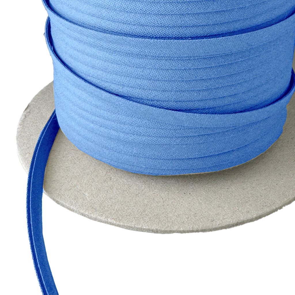 close up of the chalet blue 1/4" double fold bias tape on a spool from Heit's Wholesale bulk sewing supply company