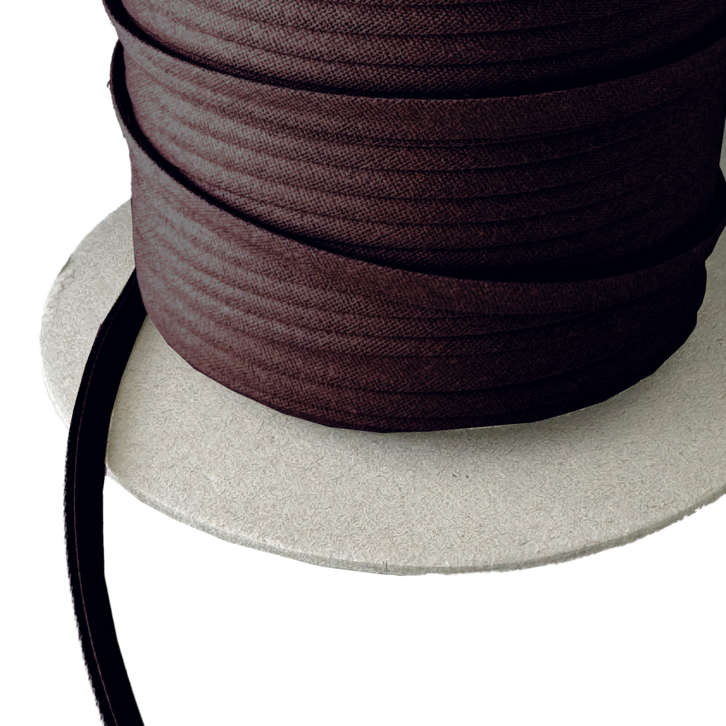 close up of the chocolate brown 1/4" double fold bias tape on a spool from Heit's Wholesale bulk sewing supply company