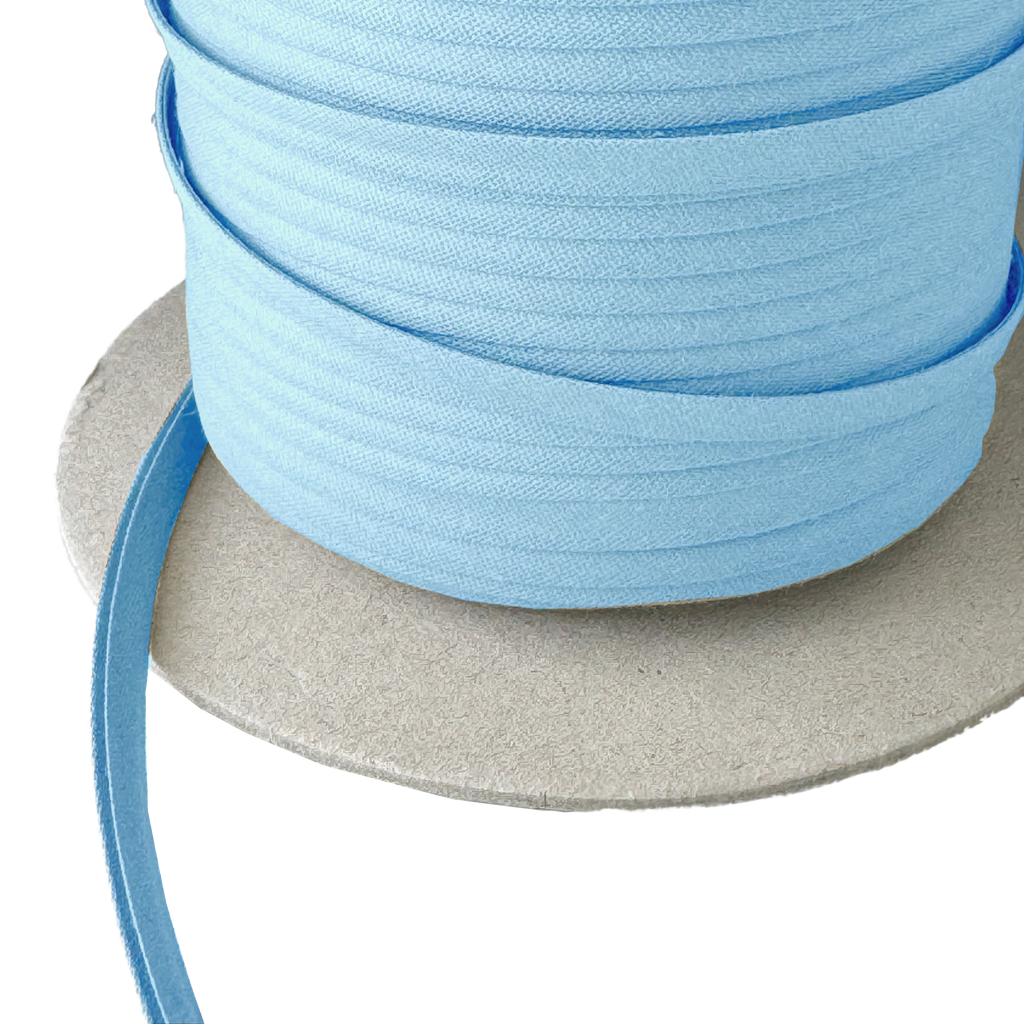 close up of the cloud blue 1/4" double fold bias tape on a spool from Heit's Wholesale bulk sewing supply company
