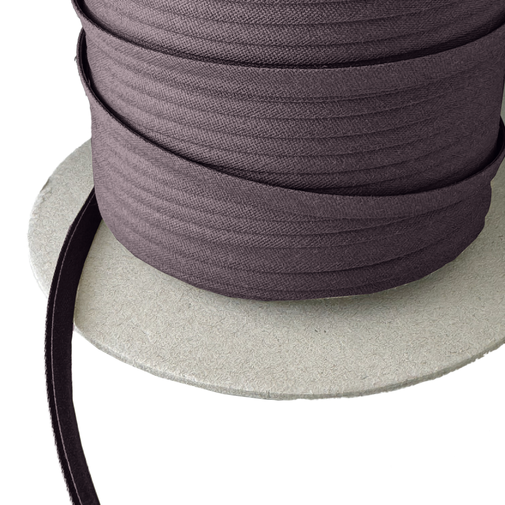 close up of the coal dust 1/4" double fold bias tape on a spool from Heit's Wholesale bulk sewing supply company