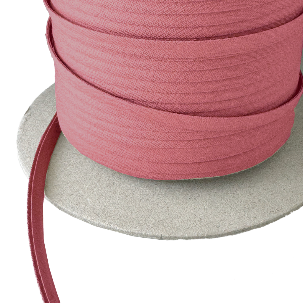 close up of the copper 1/4" double fold bias tape on a spool from Heit's Wholesale bulk sewing supply company
