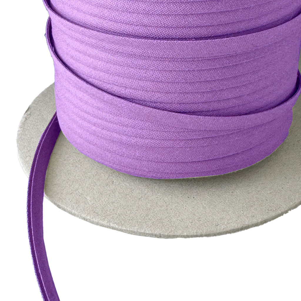 closer view of dark violet 1/4" double fold bias tape on a spool from Heit's Wholesale bulk sewing supply company