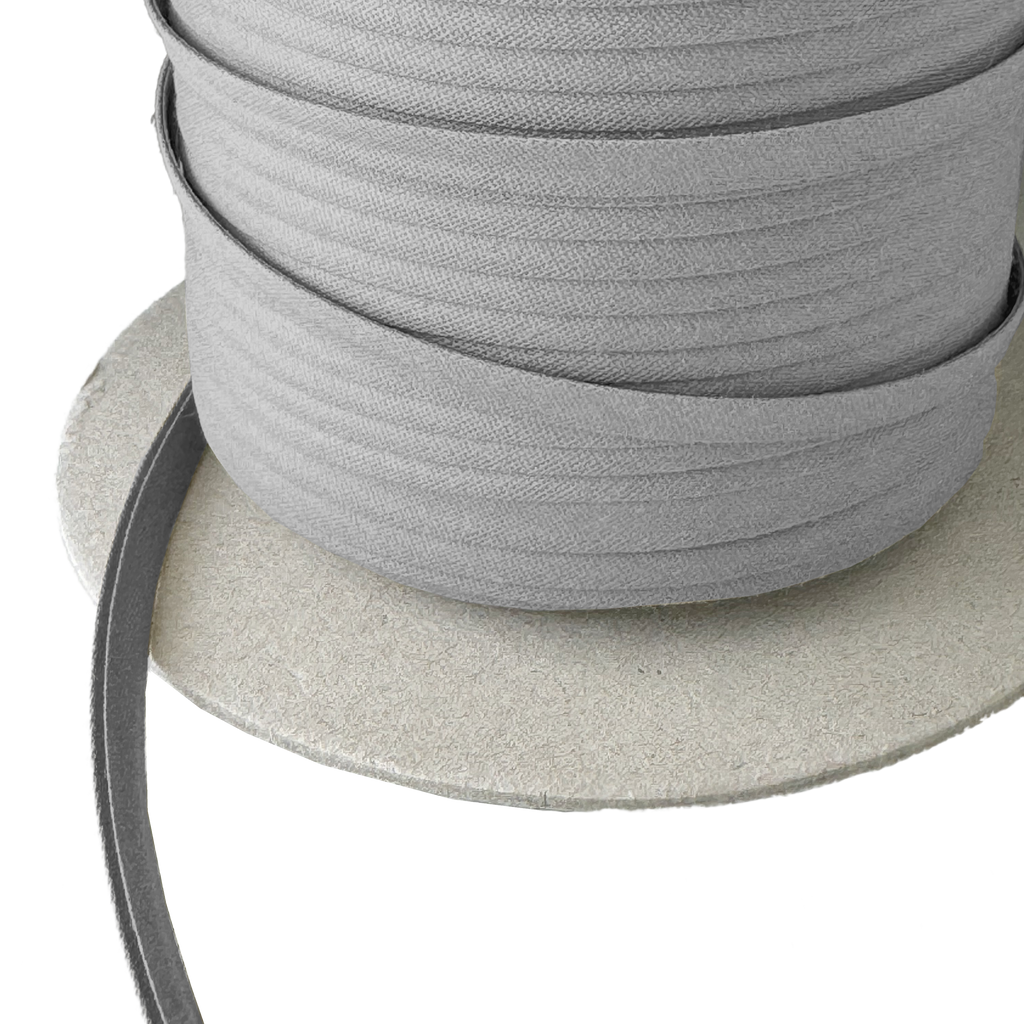 close up of the gray 1/4" double fold bias tape on a spool from Heit's Wholesale bulk sewing supply company