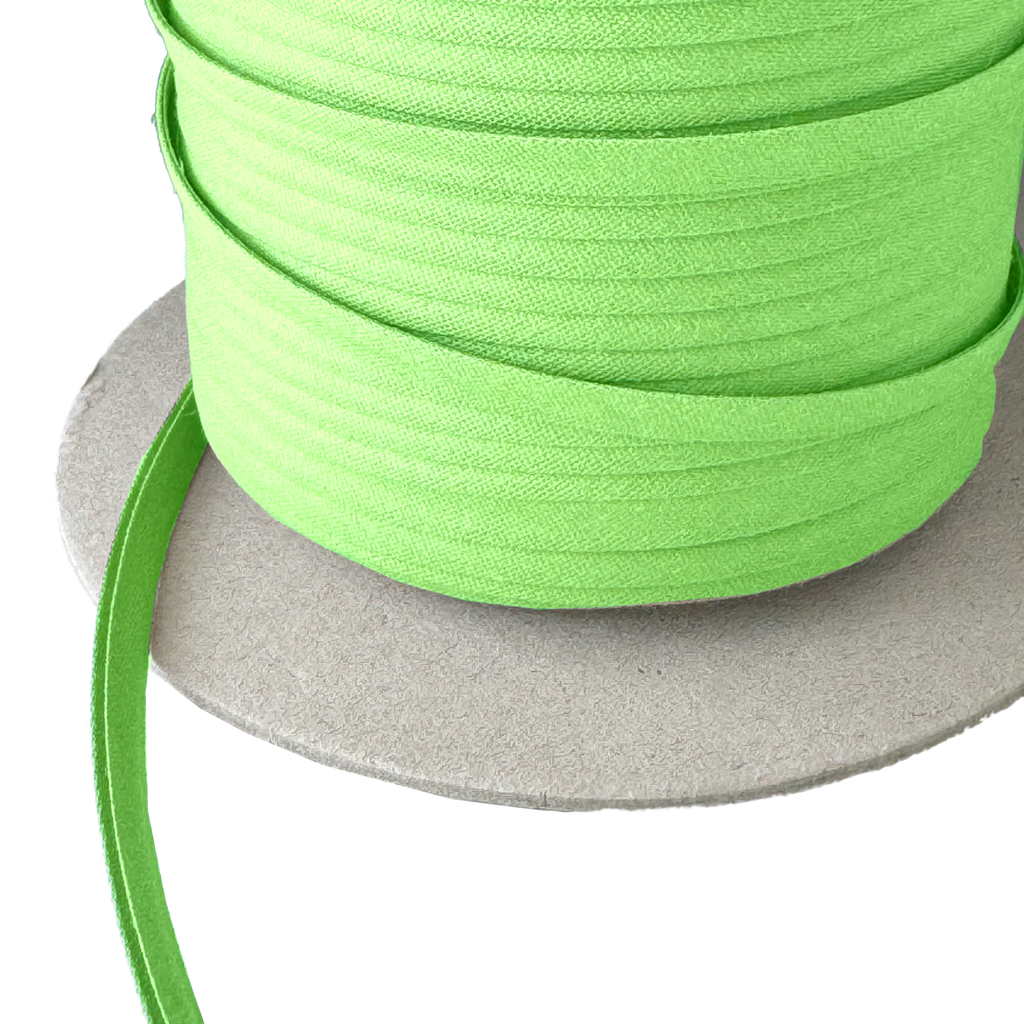 closer view of the lemon lime green 1/4" double fold bias tape on a spool from Heit's Wholesale bulk sewing supply company