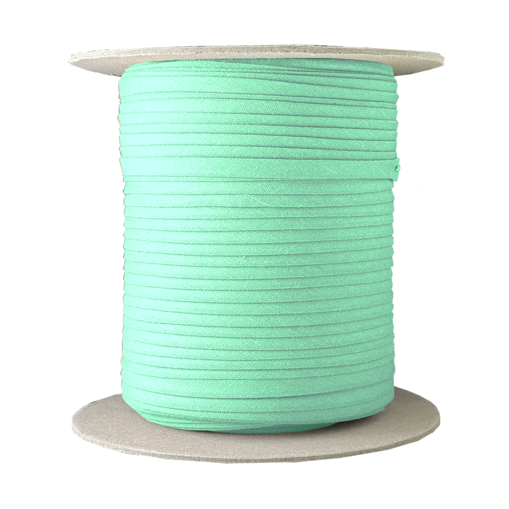 misty green 1/4" double fold bias tape on a spool from Heit's Wholesale bulk sewing supply company