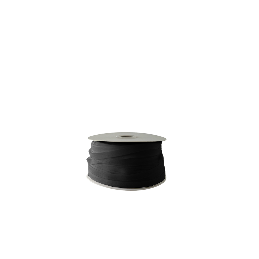 black 1/4" poly twill tape on a spool from Heit's Wholesale bulk sewing supply company
