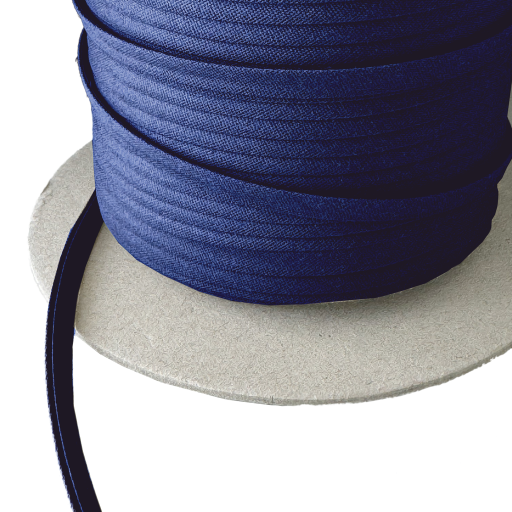 close up of the very navy 1/4" double fold bias tape on a spool from Heit's Wholesale bulk sewing supply company