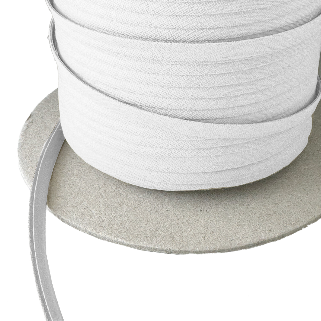 close up of the white 1/4" double fold bias tape on a spool from Heit's Wholesale bulk sewing supply company