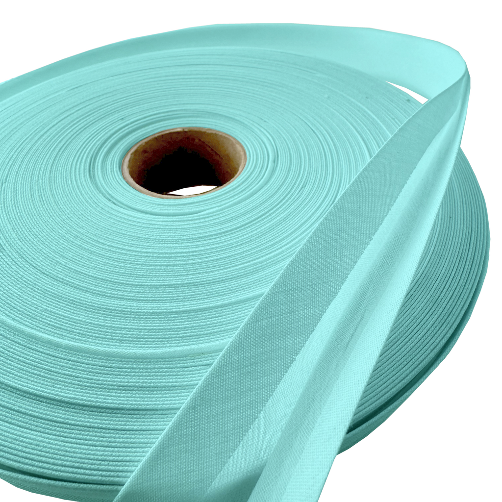 close up of the aqua 1" double fold bias tape on a roll from Heit's Wholesale bulk sewing supply company