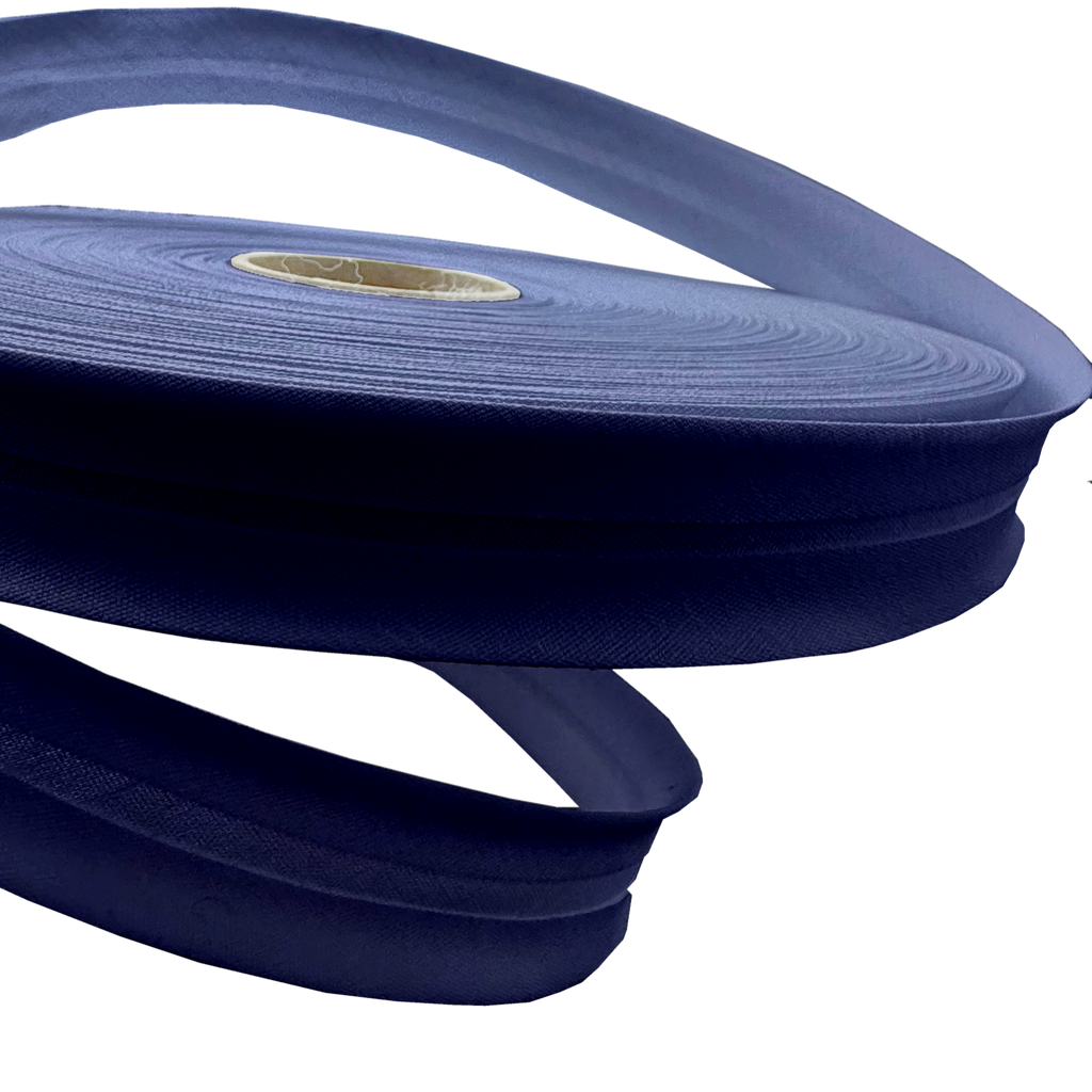 close up of the dark navy 1" no gap single fold bias tape on a roll from Heit's Wholesale bulk sewing supply company