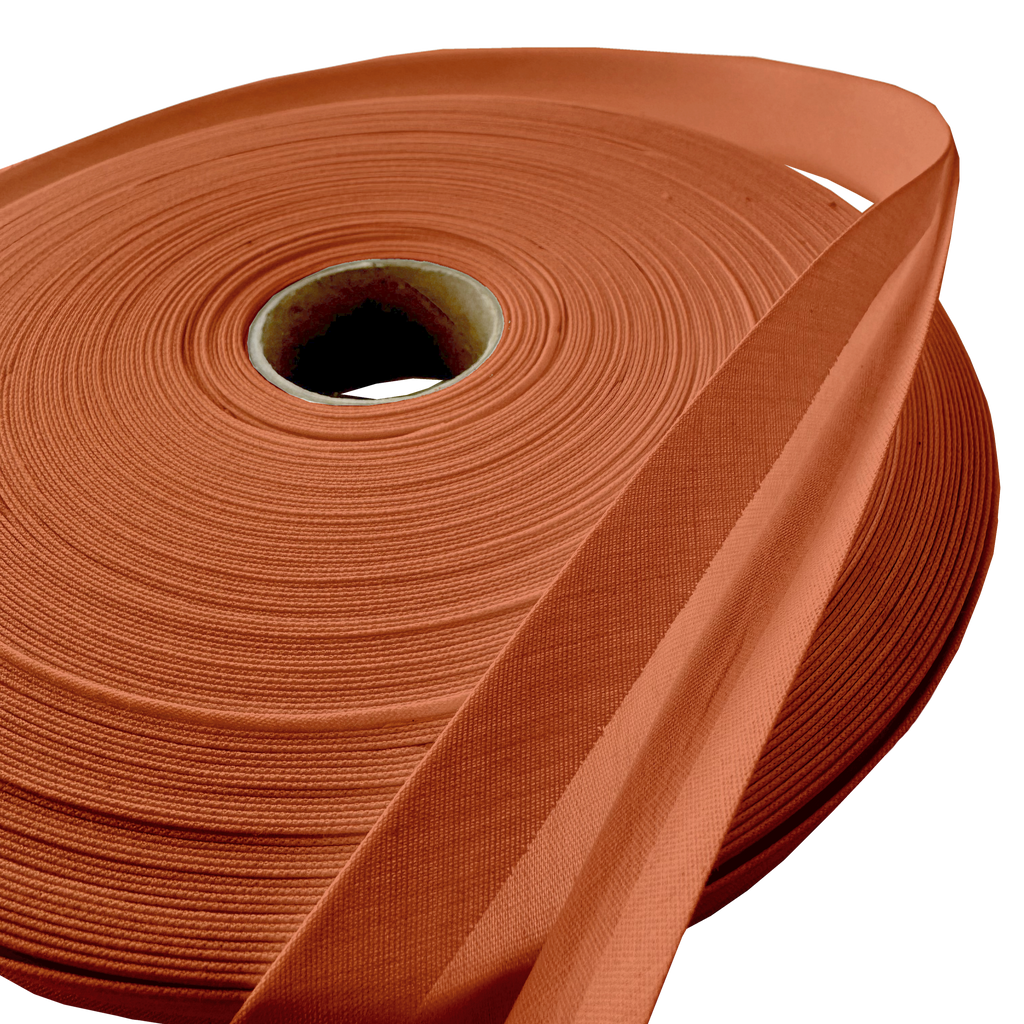 close up of the rust 1" double fold bias tape on a roll from Heit's Wholesale bulk sewing supply company
