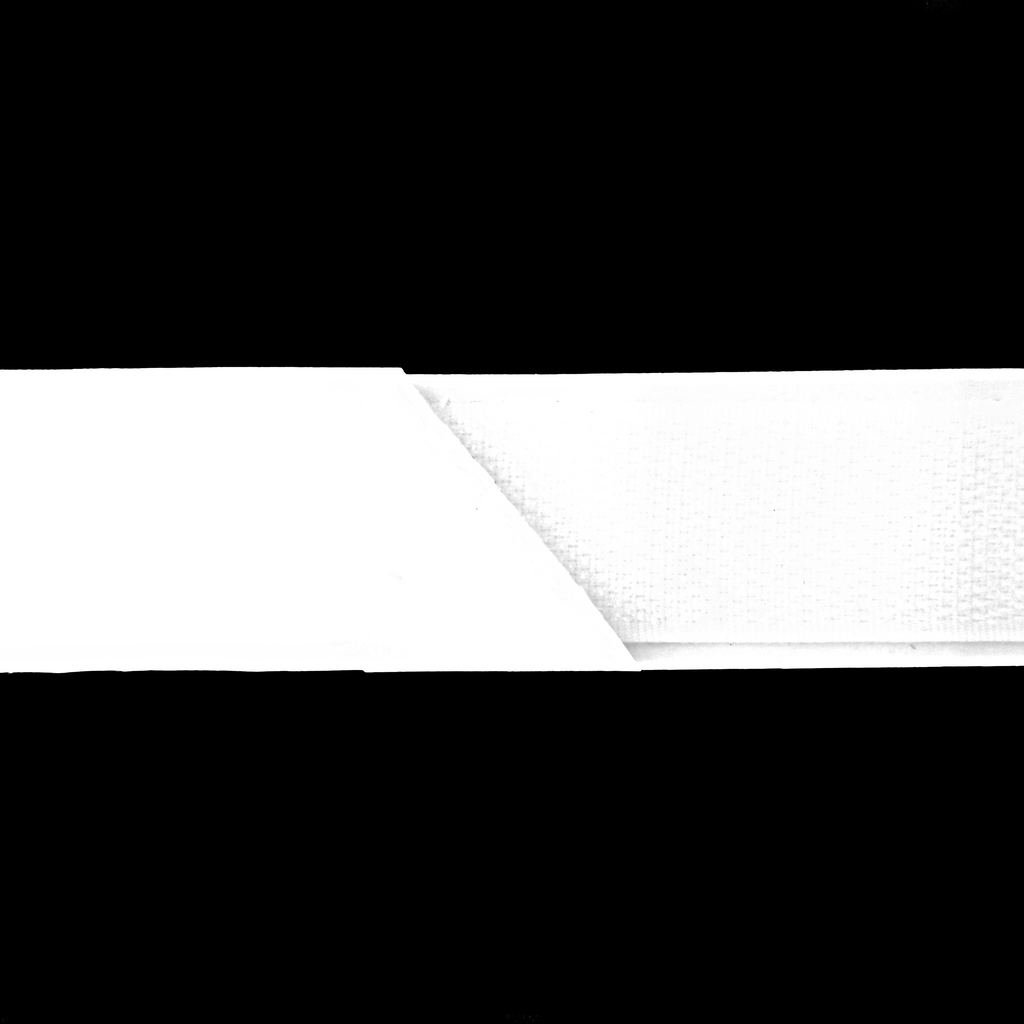 close up of the white 1" self-adhesive Velcro on a spool from Heit's Wholesale bulk sewing supply company