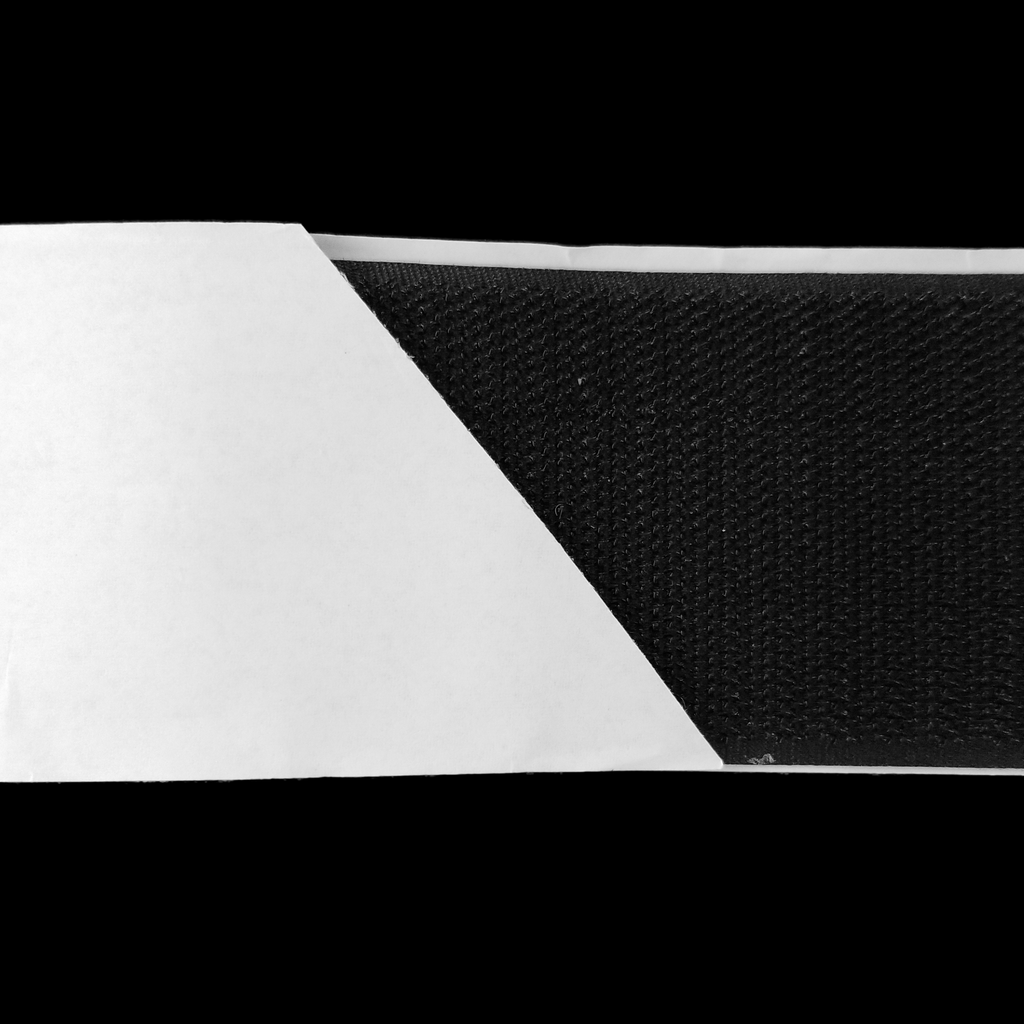 close up of the black 2" self-adhesive Velcro on a spool from Heit's Wholesale bulk sewing supply company