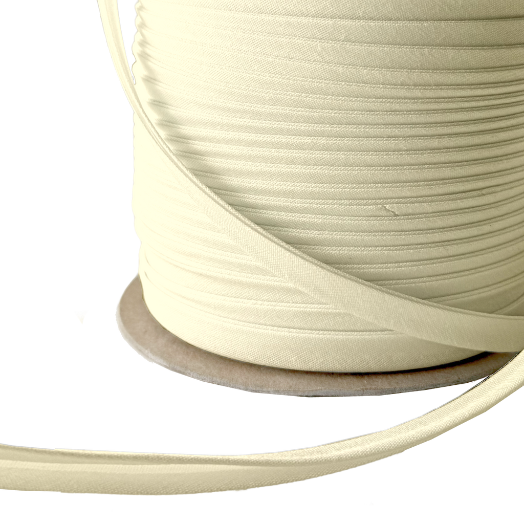 close up of the bamboo 3/8" double fold bias tape on a spool from Heit's Wholesale bulk sewing supply company 