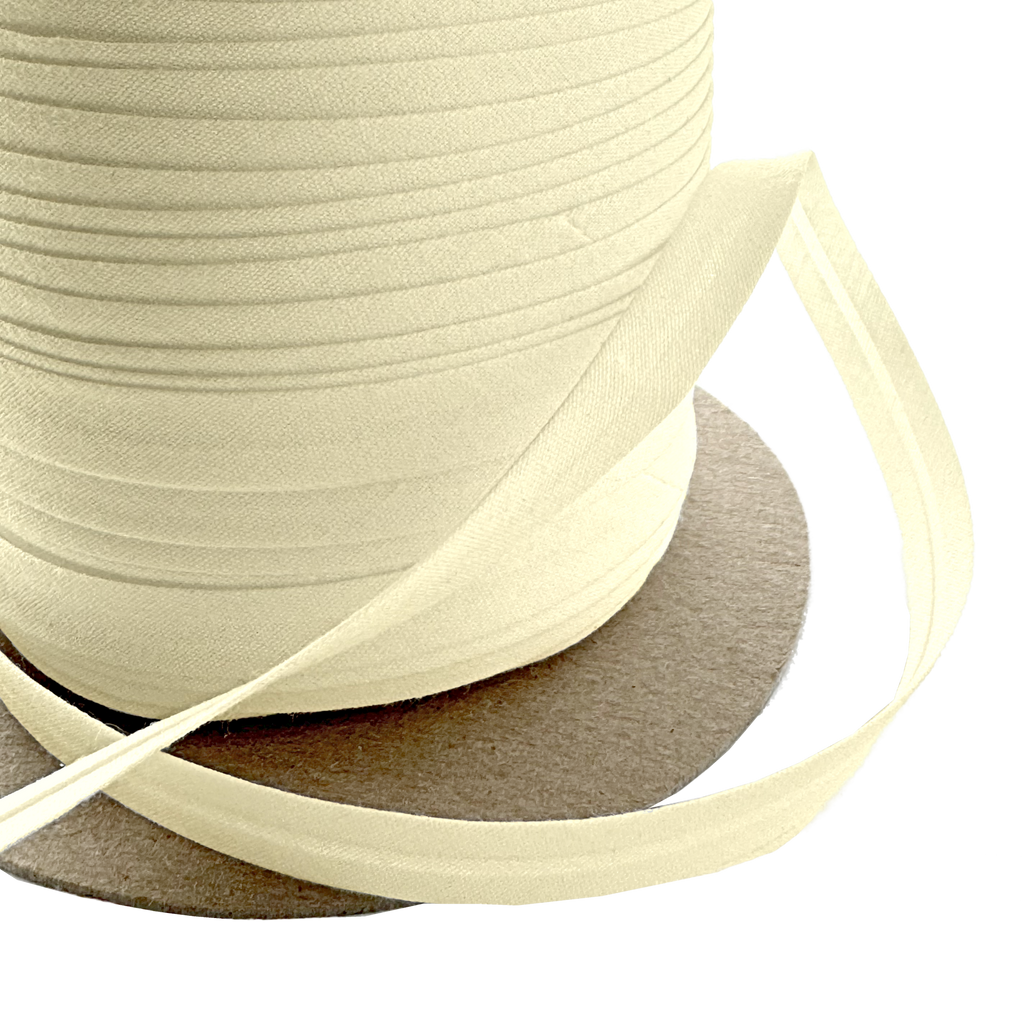 close up of the bamboo 3/8" single fold bias tape on a spool from Heit's Wholesale bulk sewing supply company