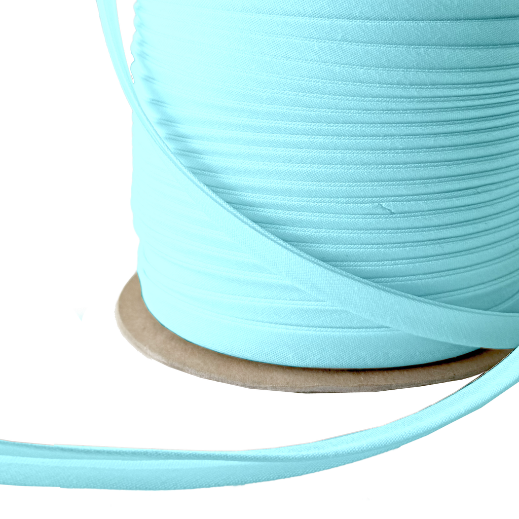close up of the blue 3/8" double fold bias tape on a spool from Heit's Wholesale bulk sewing supply company 