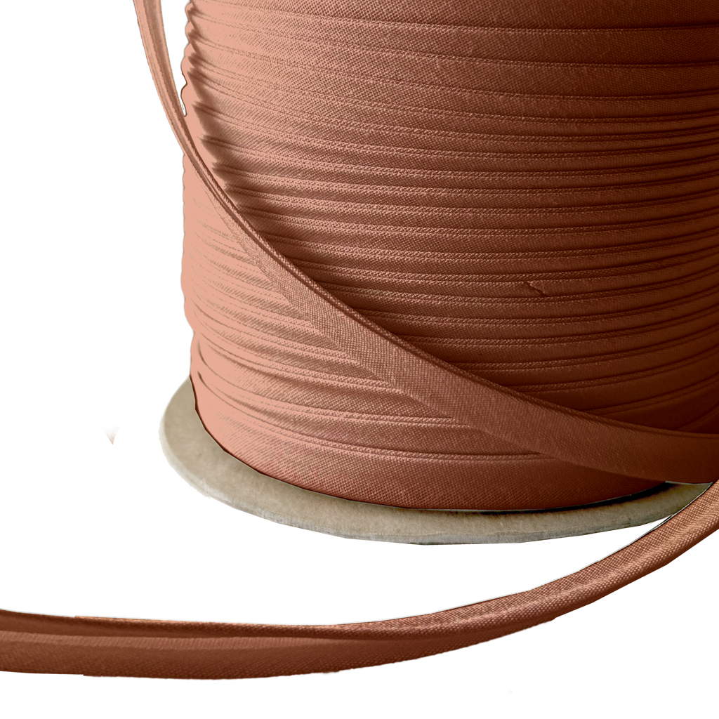 close up of the brown 3/8" double fold bias tape on a spool from Heit's Wholesale bulk sewing supply company 