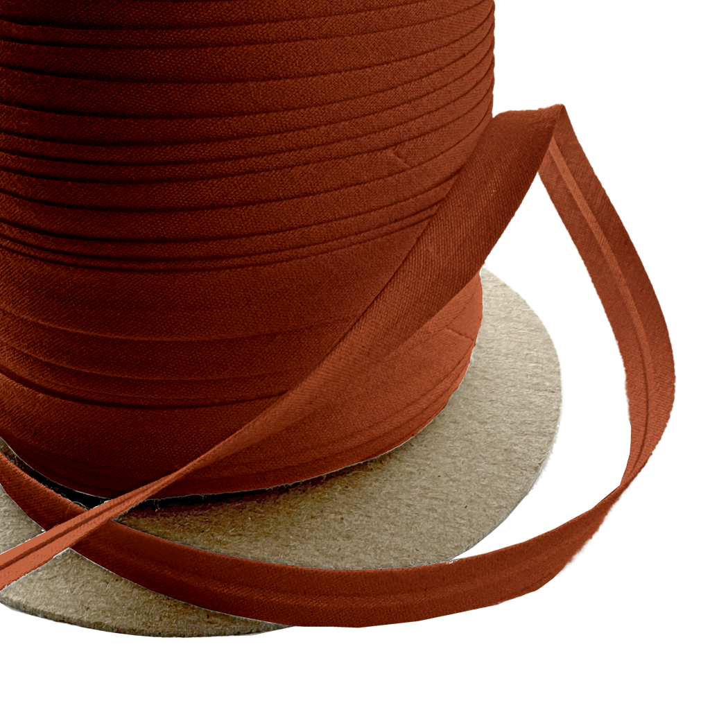 close up of the brown 3/8" single fold bias tape on a spool from Heit's Wholesale bulk sewing supply company