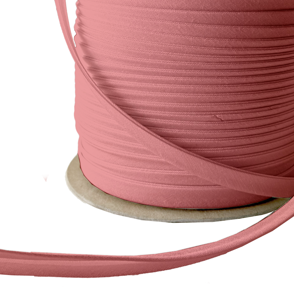 close up of the copper 3/8" double fold bias tape on a spool from Heit's Wholesale bulk sewing supply company 