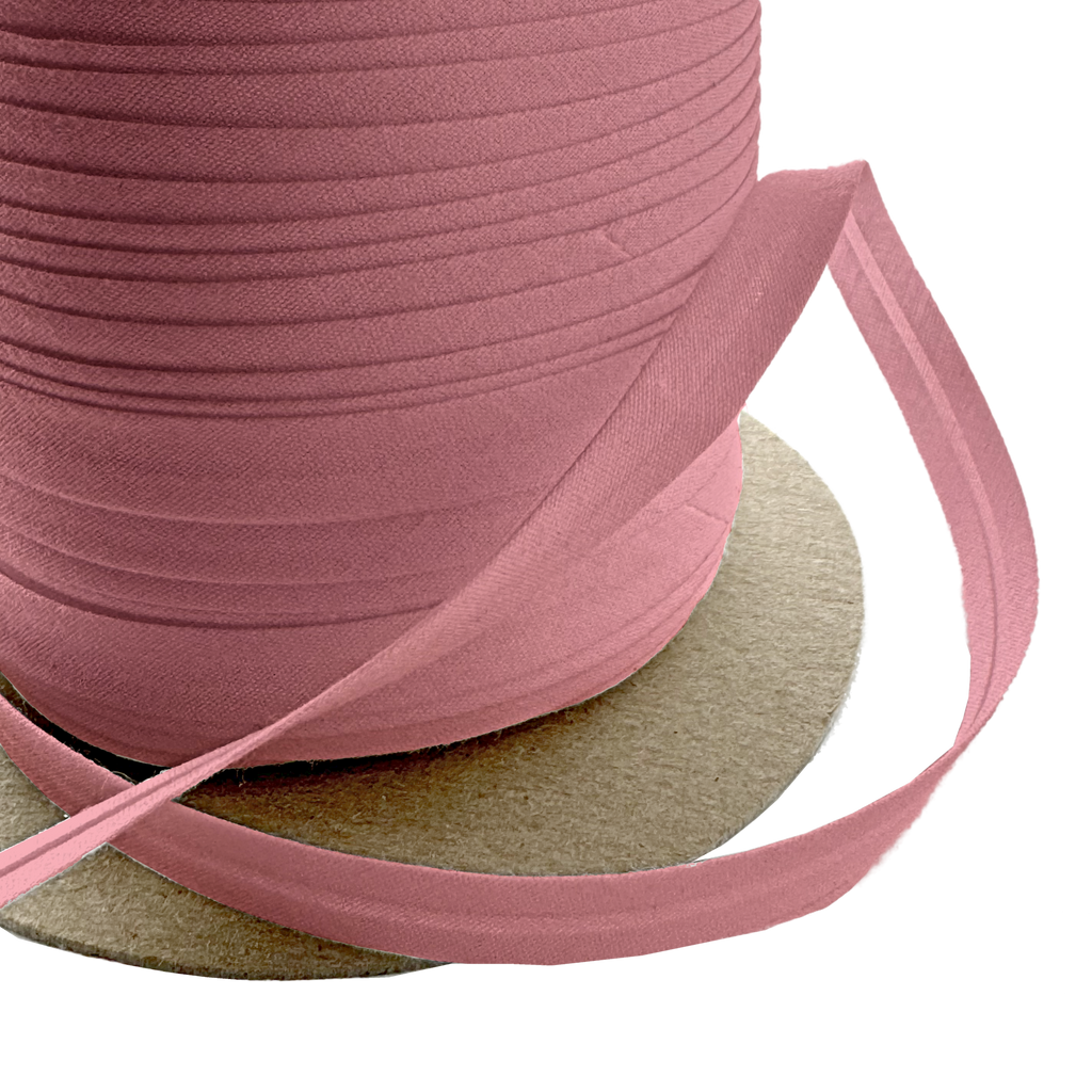 close up of the copper 3/8" single fold bias tape on a spool from Heit's Wholesale bulk sewing supply company