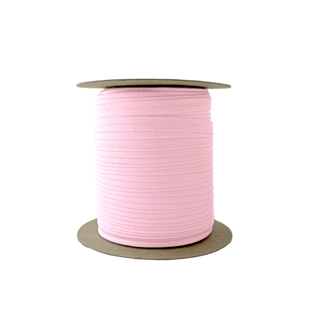 petal pink 3/8" single fold bias tape on a spool from Heit's Wholesale bulk sewing supply company