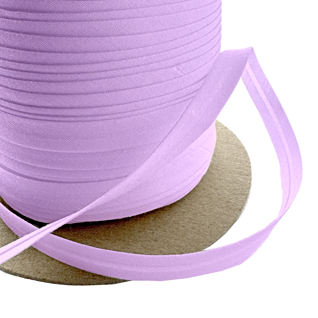 close up of the violet 3/8" single fold bias tape on a spool from Heit's Wholesale bulk sewing supply company