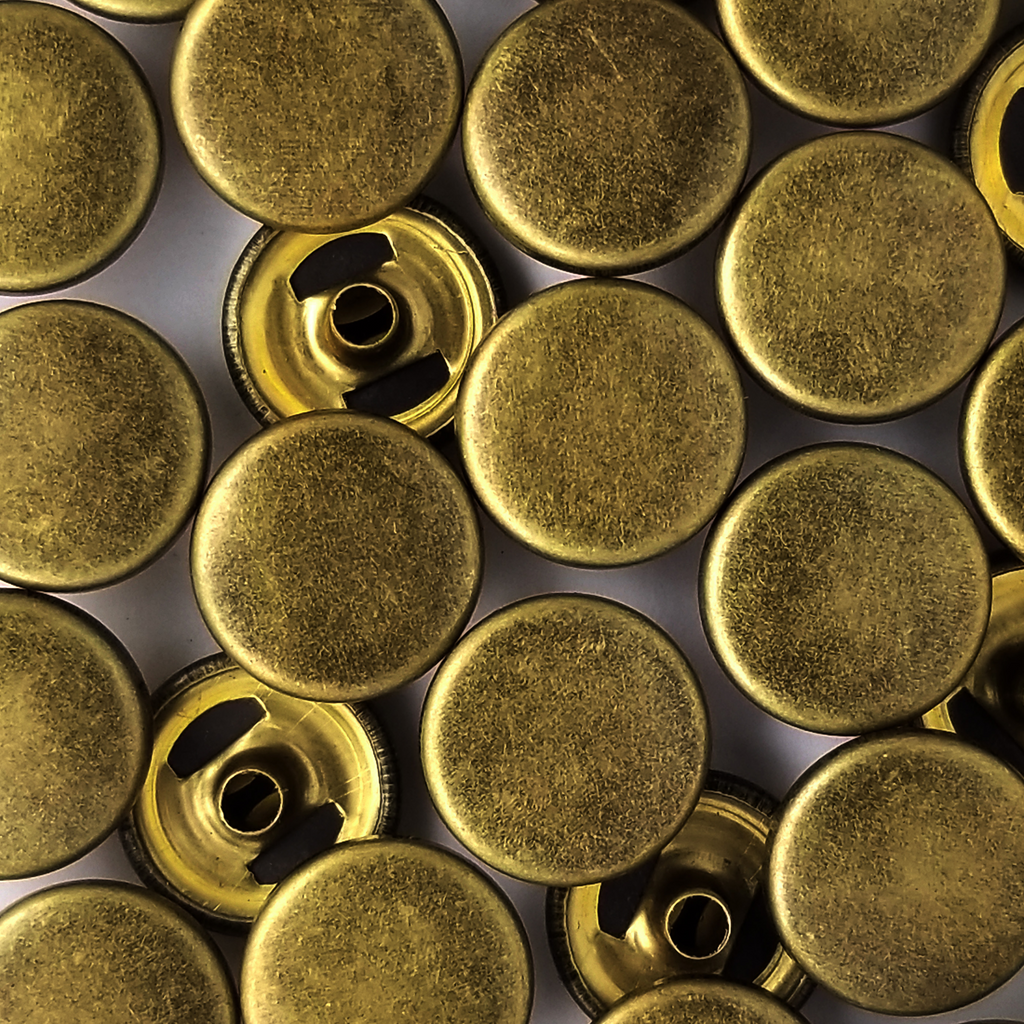 group of the antique brass size 20 spring snap for lightweight jackets at Heit's Wholesale bulk sewing supply company
