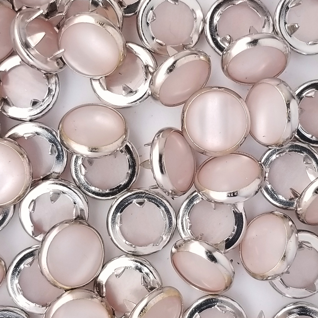 group of the baby pink size 14 child sized pearl snaps from Heit's Wholesale bulk sewing supply company