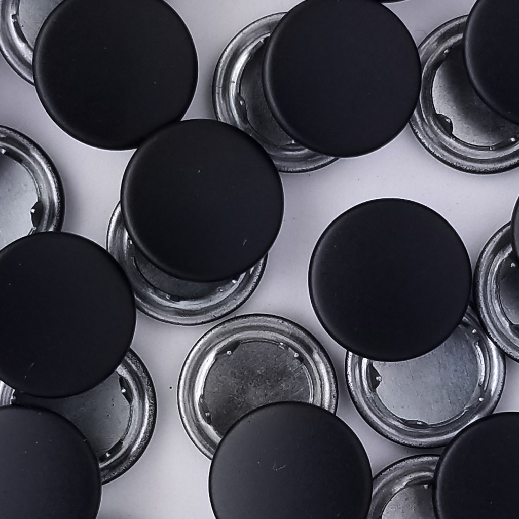 group of the black size 18 capped snaps from Heit's Wholesale bulk sewing supply company 