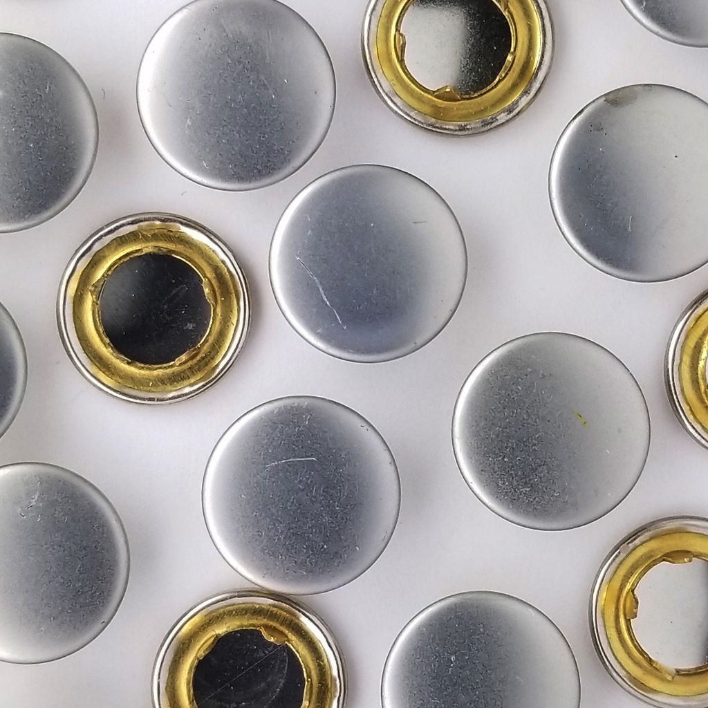 group of the brushed silver size 20 capped gripper snaps from Heit's Wholesale bulk sewing supply company