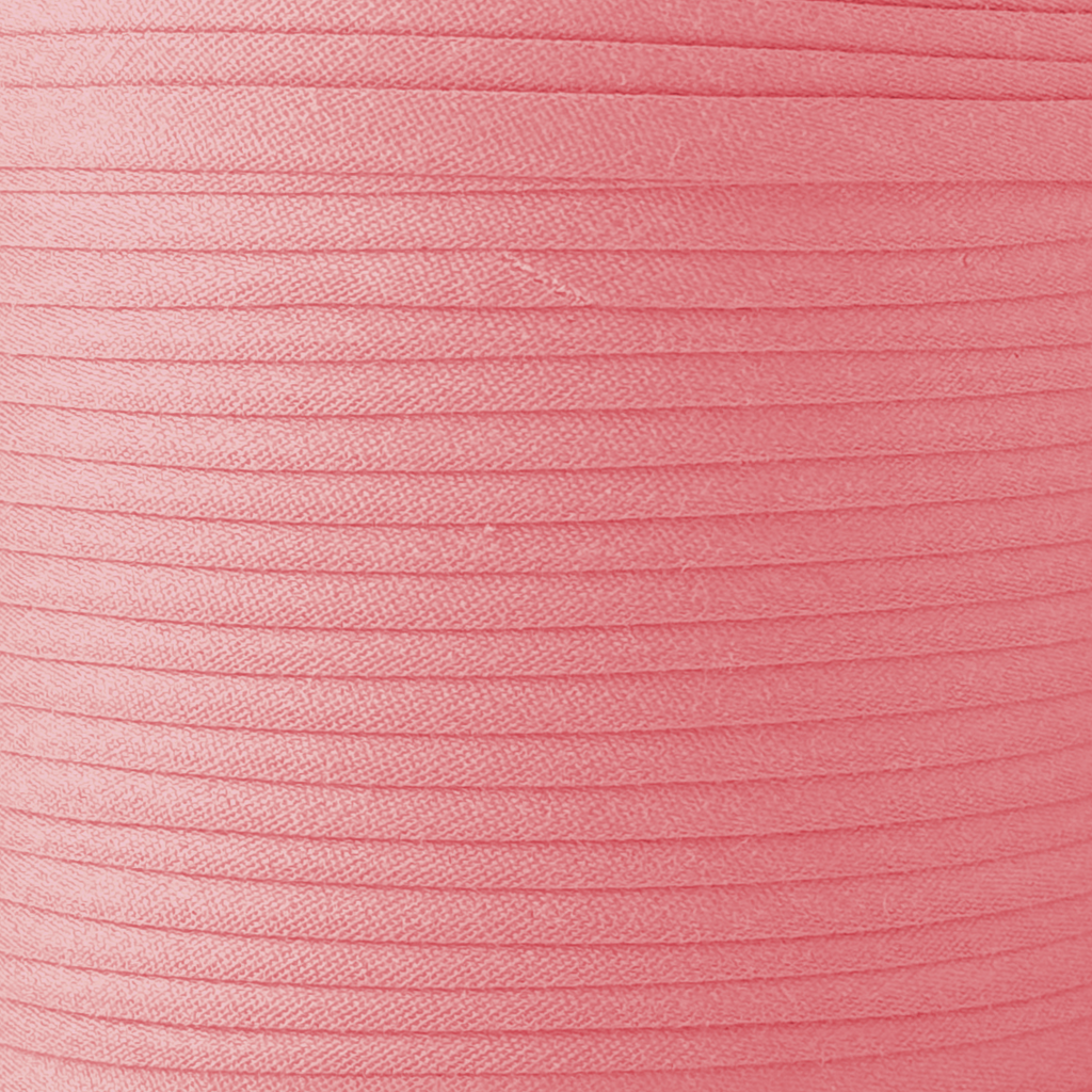 color swatch of the coral pink 1/2" double fold bias tape on a spool from Heit's Wholesale bulk sewing supply company
