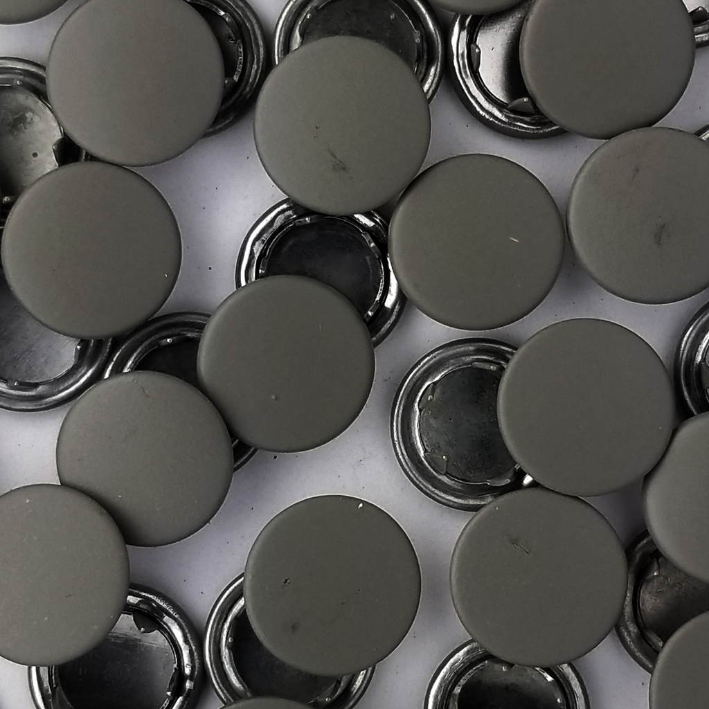 close up of the dark tan size 14 capped snaps with a matte finish from Heit's Wholesale bulk sewing supply company